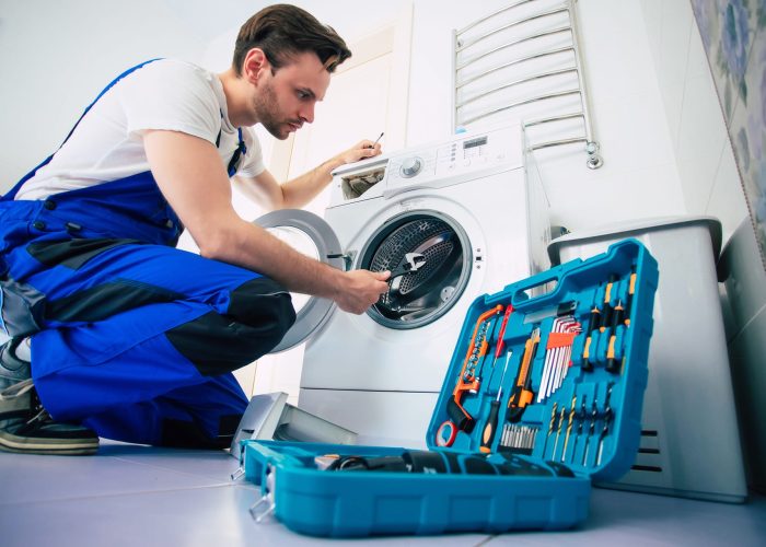 young-handsome-repairman-worker-suit-with-professional-tools-box-is-fixing-washing-machine-bathroom (1)